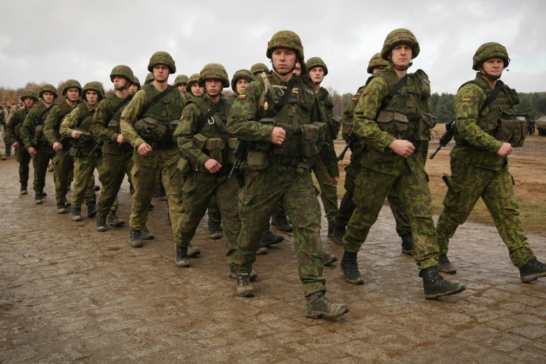 soldiers marching and holding guns down a path