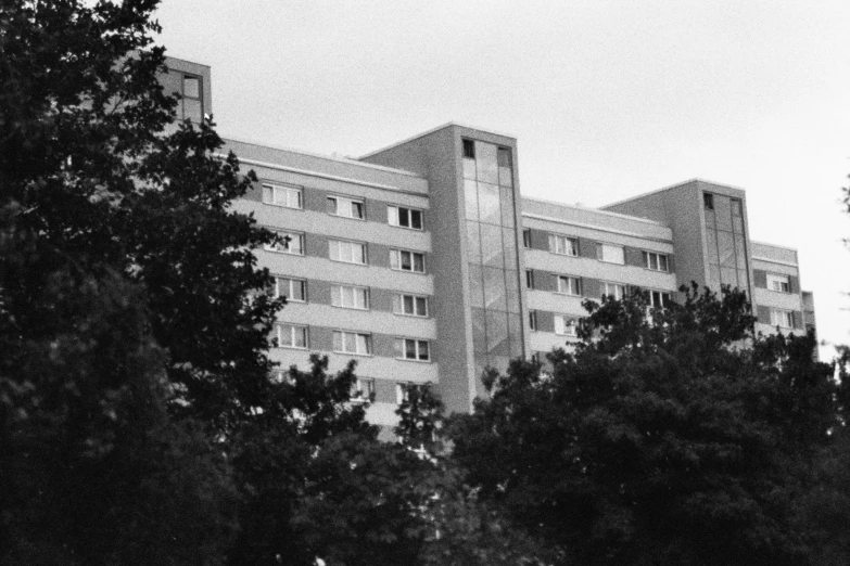 two buildings near each other with trees in front of them