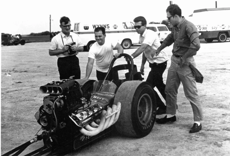 men around a car being developed for flying