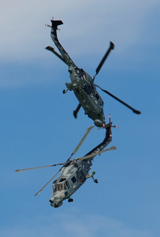a couple of black and gray helicopter flying together