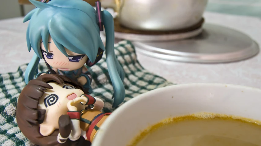 a anime doll that is sitting next to a bowl