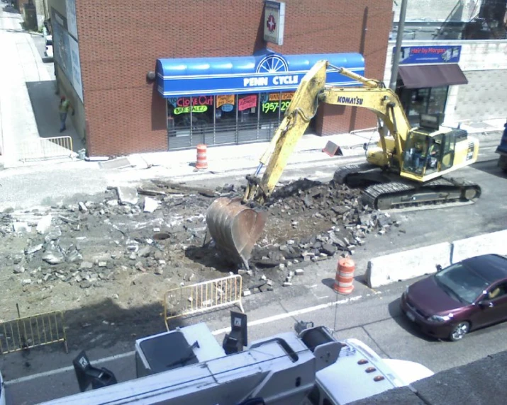 construction site on the street, including a construction vehicle