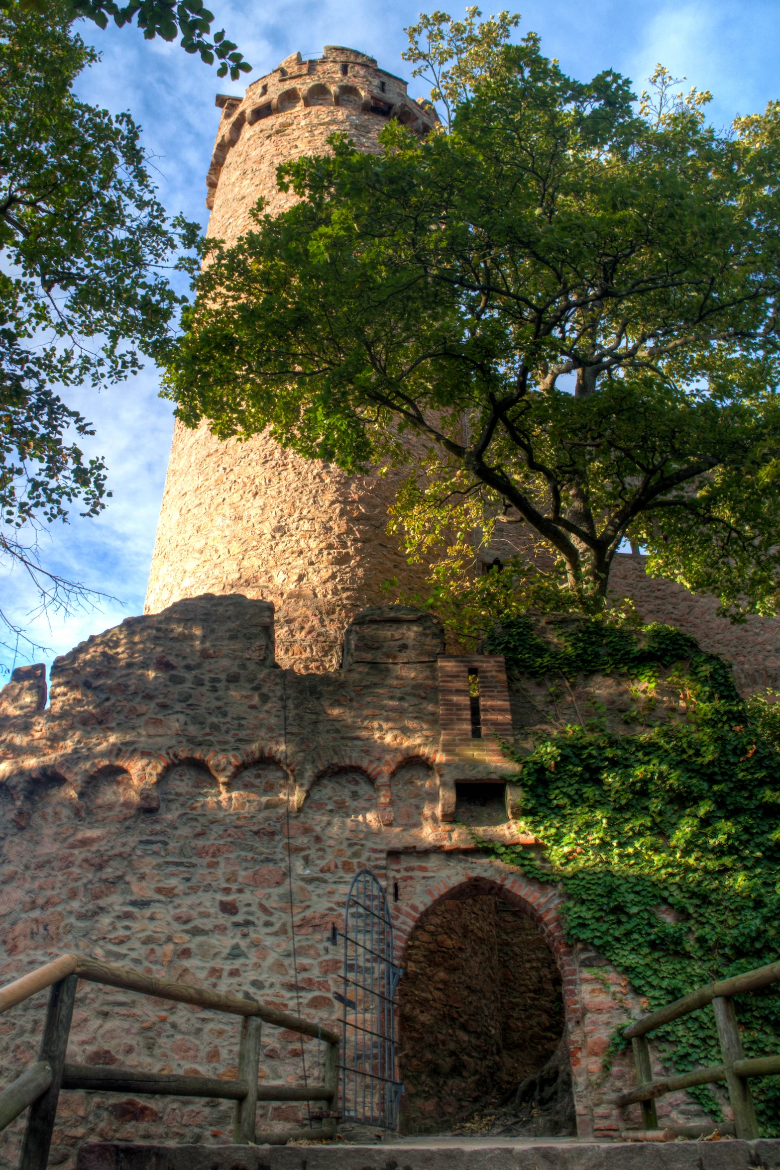 a very large old brick tower near some trees