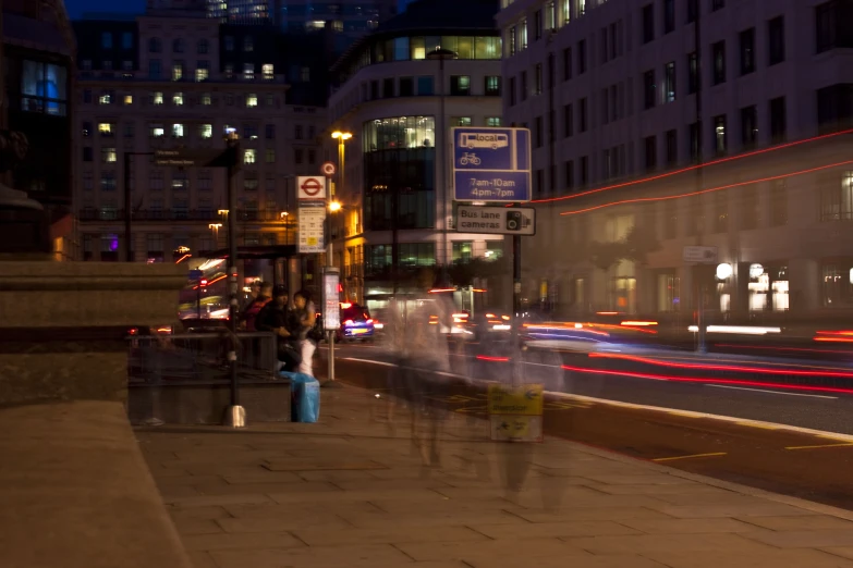 a view of street at night with people in the street