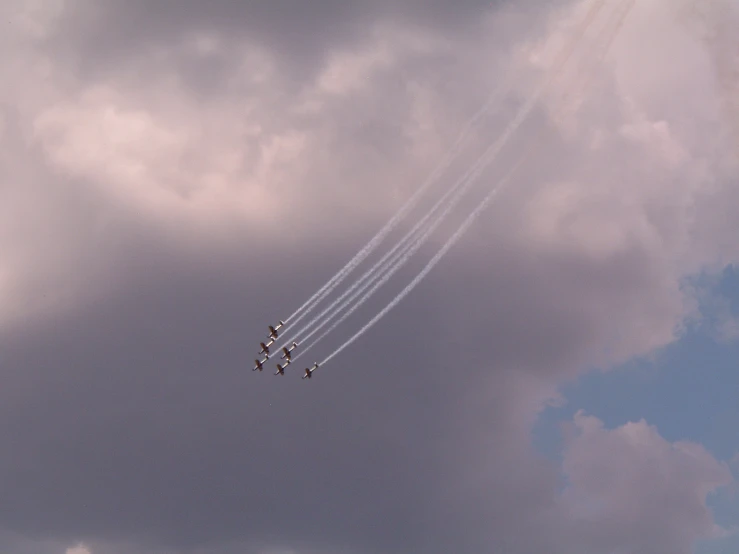 an image of four jets flying in the sky