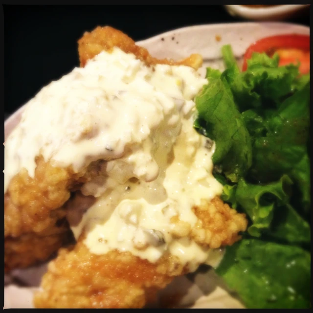 a plate with a salad and fried chicken