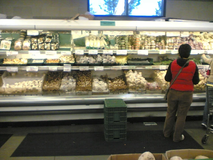 two people looking through the produce in a display