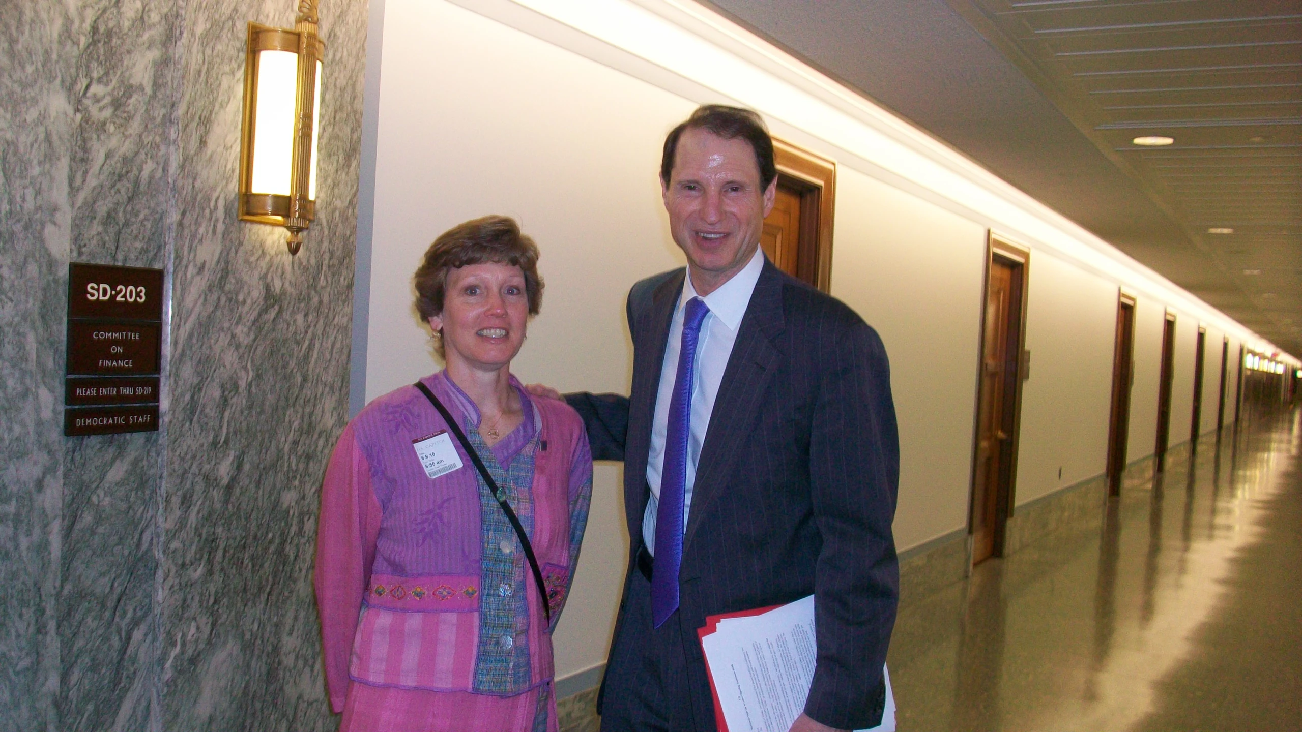 a man in a suit and tie standing next to a woman