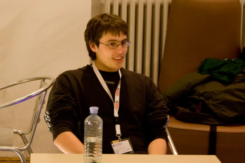 a man sitting down with a bottle in his hand