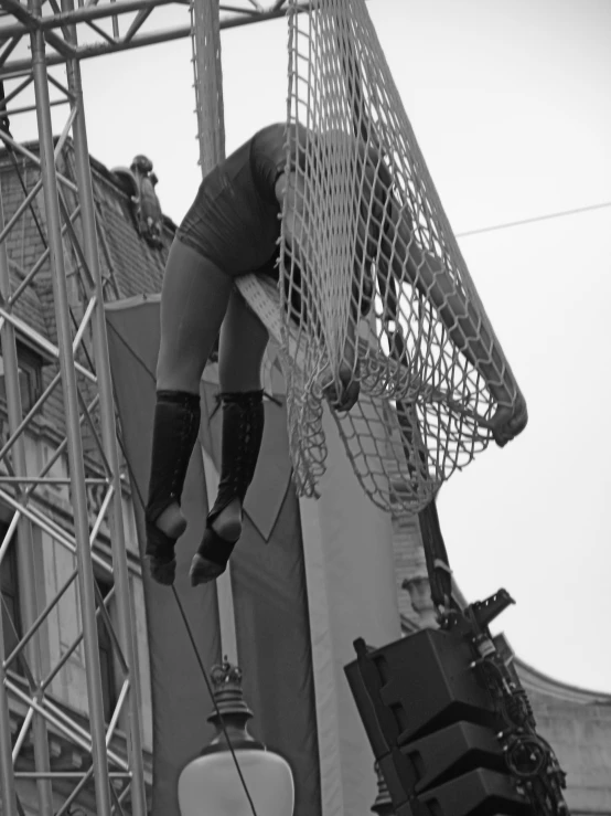 a man hanging from a net during a game