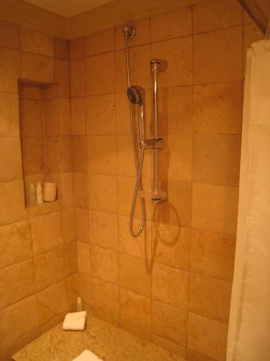 there is a shower with a hose attached to it