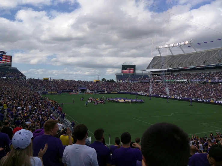 a crowded stadium filled with people watching a game