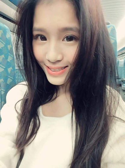an asian girl smiling with long black hair