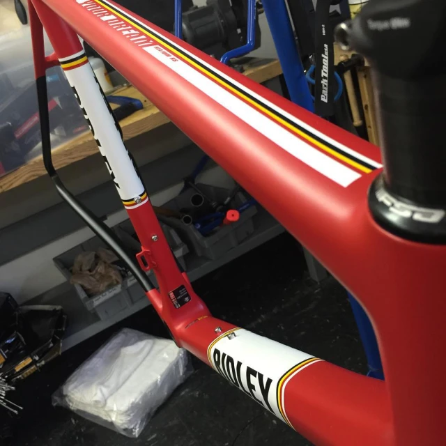 red and yellow bike being worked on in a shop