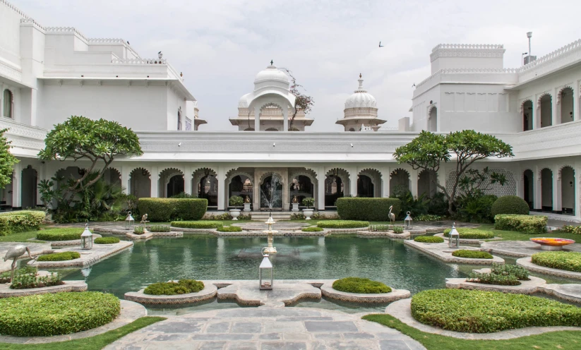 the courtyard of a palace with a fountain and landscaping
