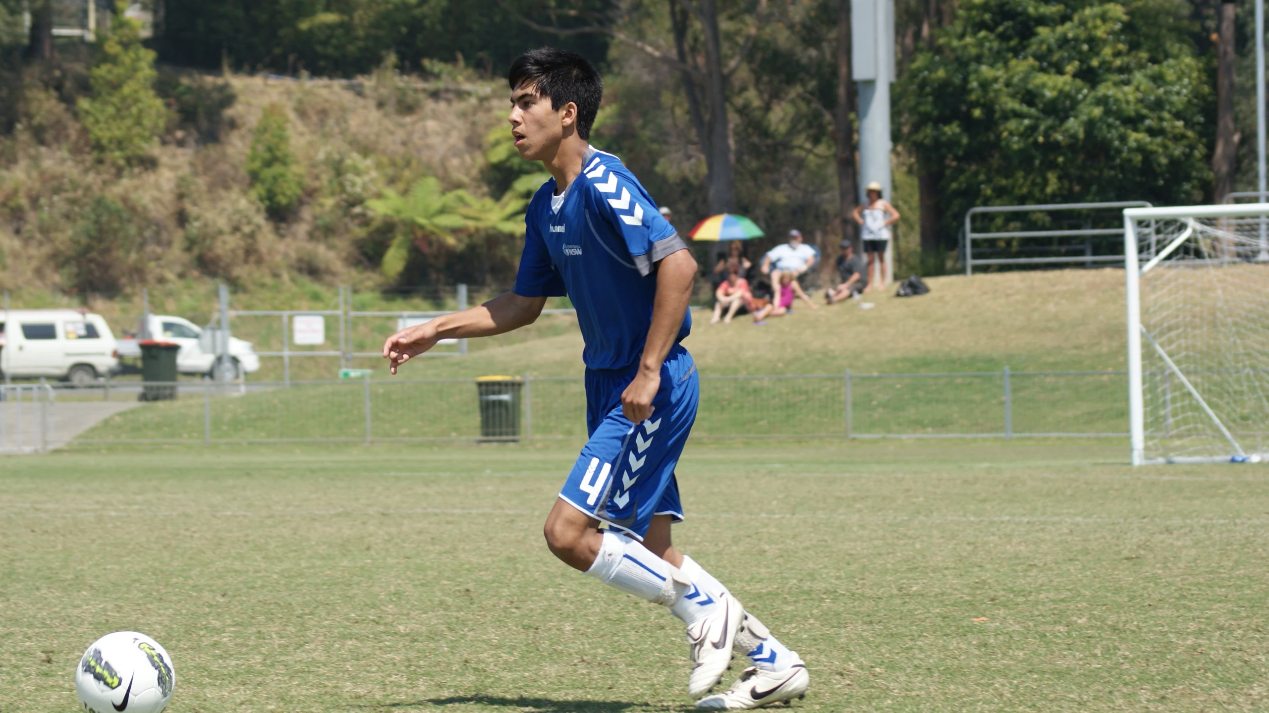 a man standing on top of a field next to a soccer ball