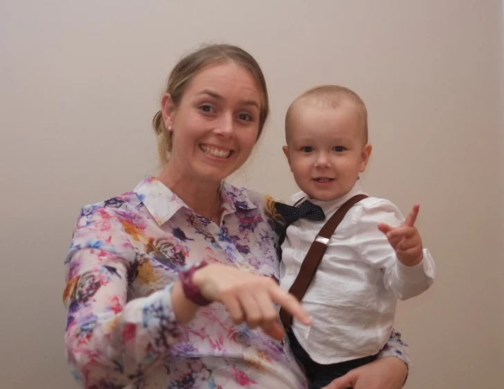 a woman is giving a thumbs up sign