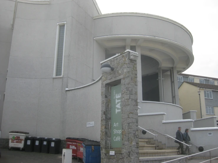 a white building with a large round entrance