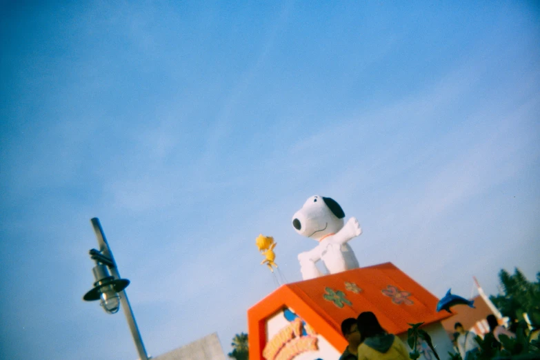 a fake dog that is sitting on top of a truck