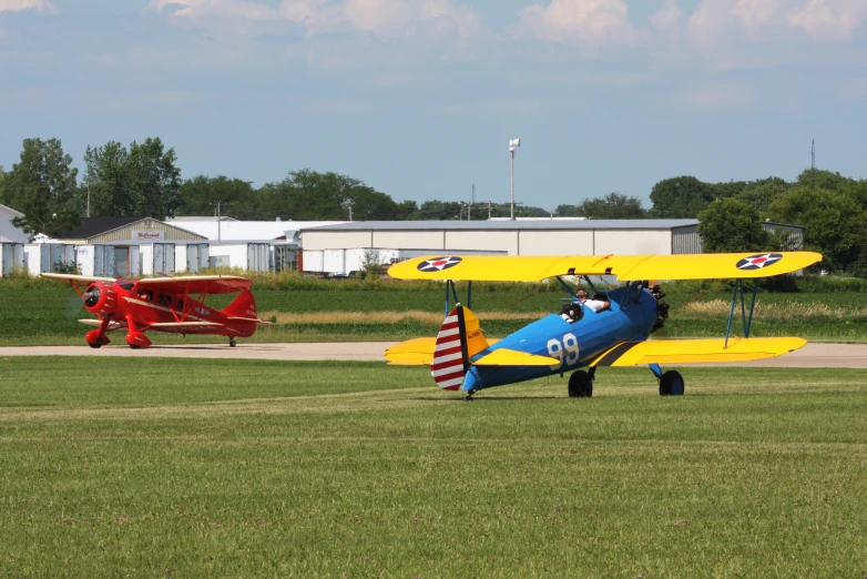 a small plane is standing on some grass