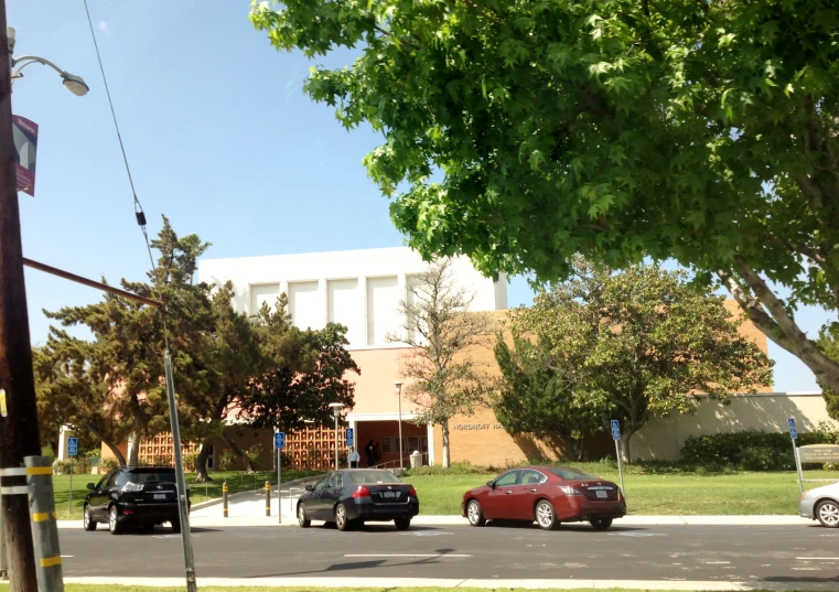 a street lined with traffic next to a brick building