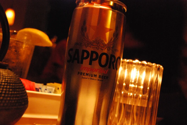 a bottle of tappor and a can of beer sitting on the bar