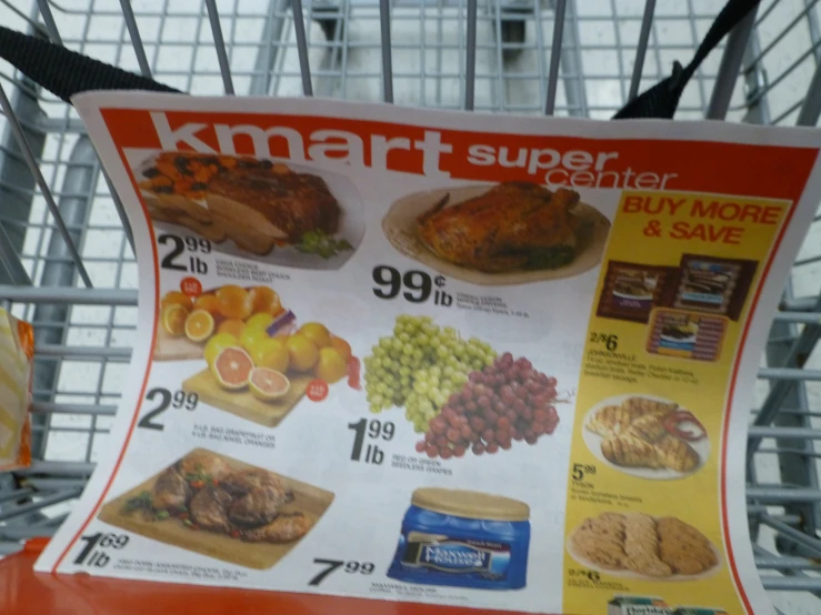 the poster for kmart super fresh market on the side of the road