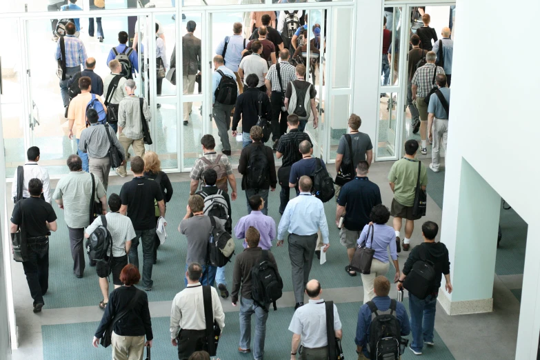 group of people walking together with one using a cell phone