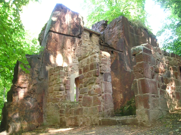 an old stone building with large windows and a doorway