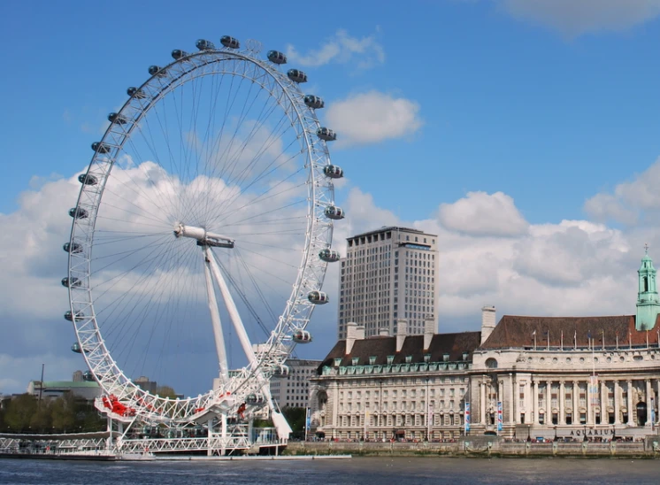 a large ferris wheel sitting next to a large building