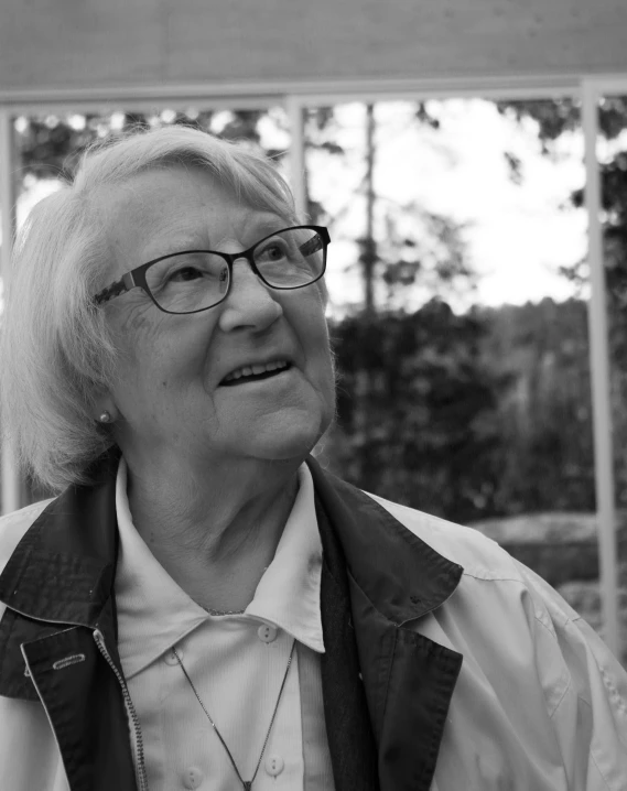 an old woman wearing glasses and a white shirt