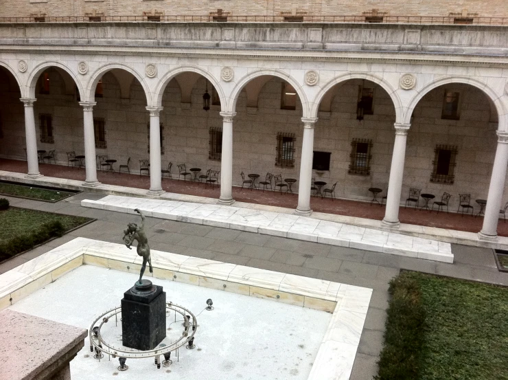 a courtyard has tables and chairs inside