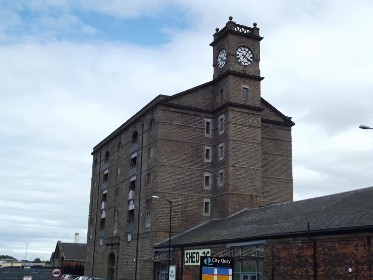 a brick building with a clock on it in the day