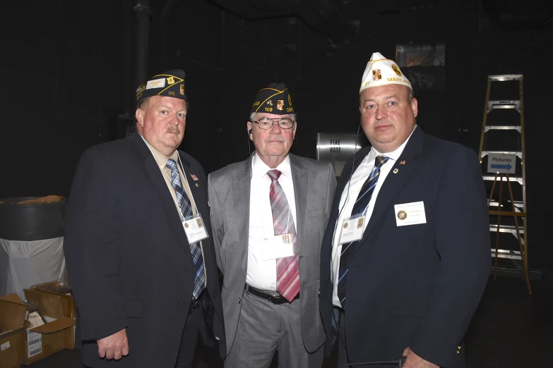 three men are wearing formal hats and ties