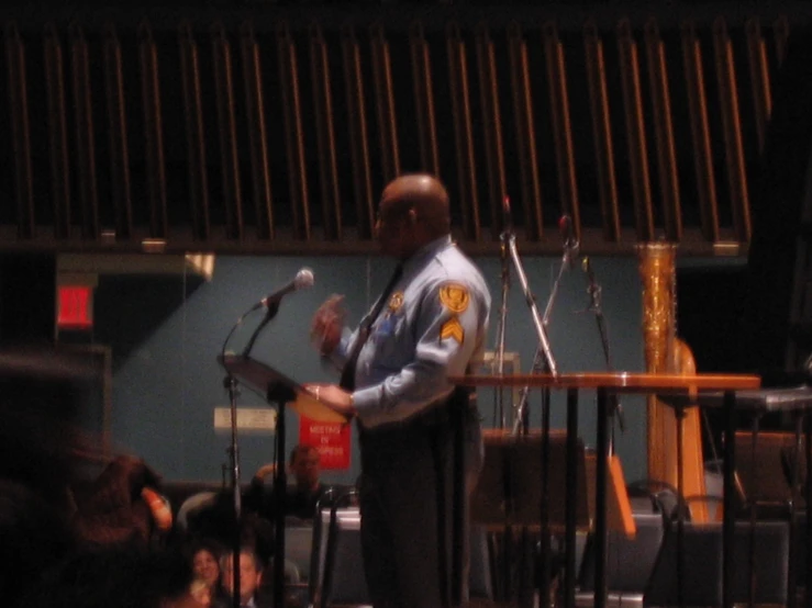 a man holding a microphone next to some keyboards