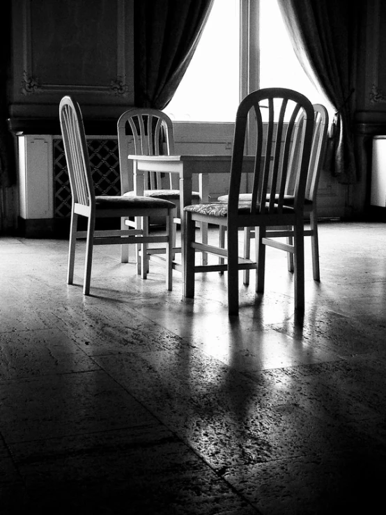 a living area with chairs and table in black and white