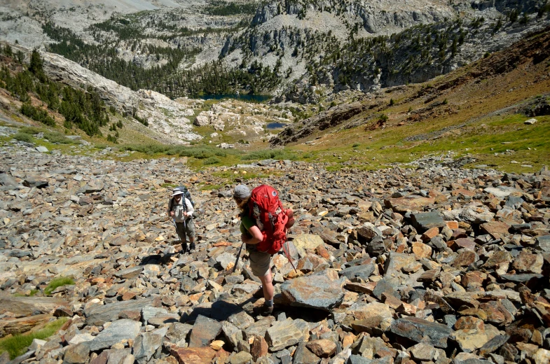 two men hiking through a rocky area