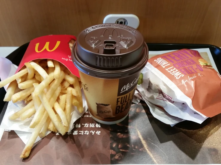 a close up of a tray of food with french fries