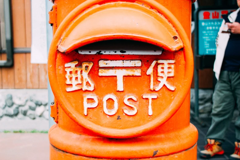 a bright orange post has the words post posted