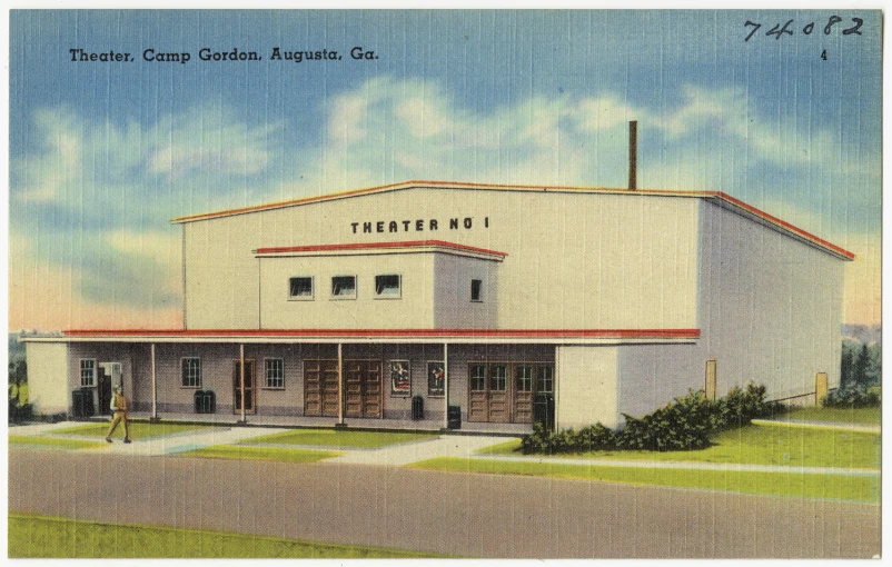 a picture of a white building with green plants on the corner