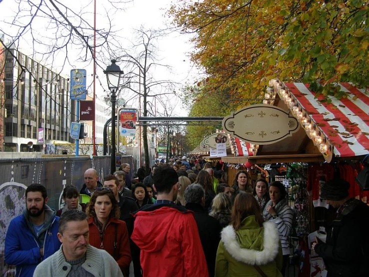 the people are walking along the path of the fair