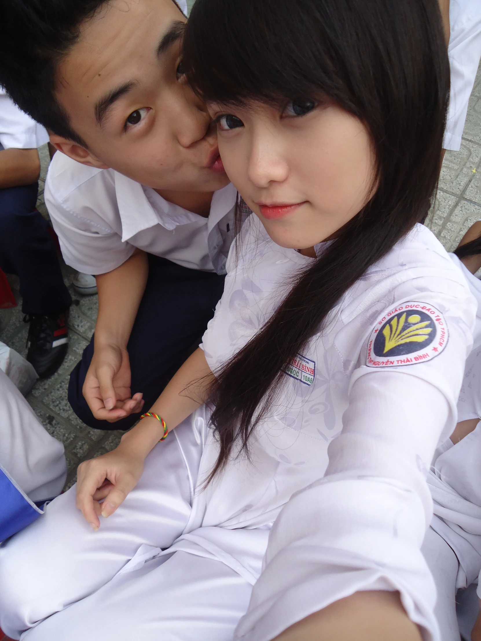 two asian women in uniforms posing for the camera