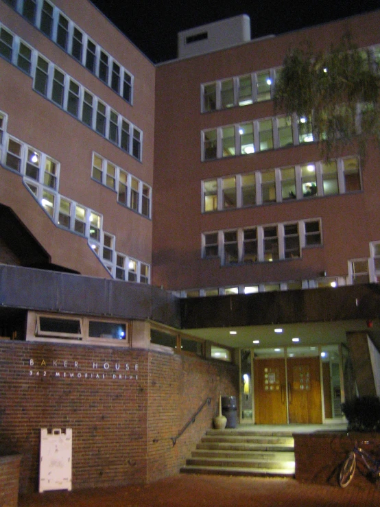 a building with a clock in front of it at night