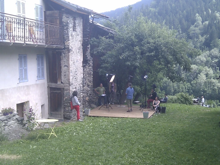 a group of people outside on the deck of a home