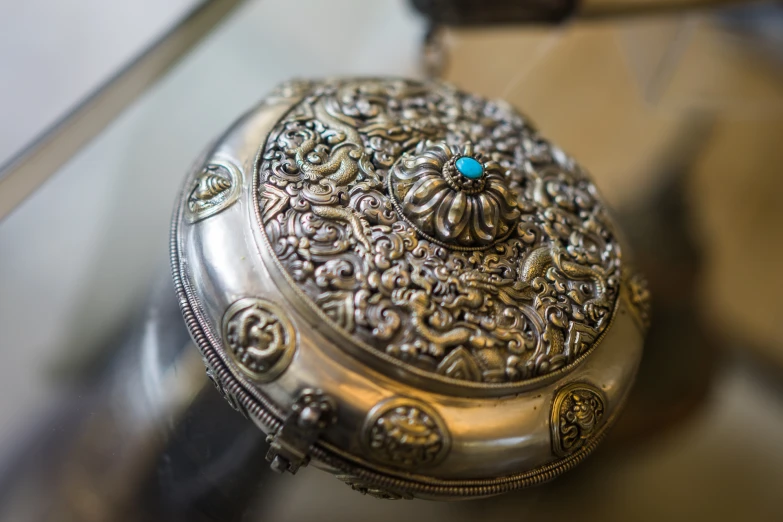 an ornate looking metal box on a display