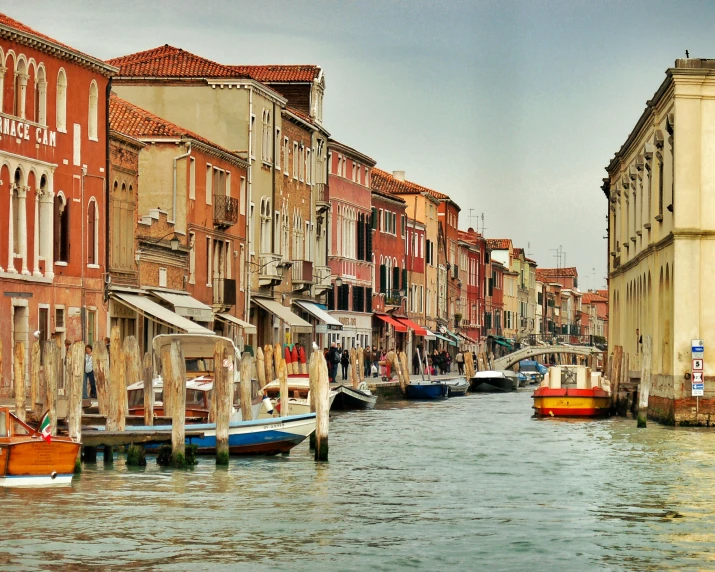 a canal filled with water next to tall buildings