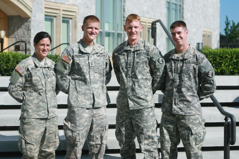 four men and women in military fatigues standing next to each other