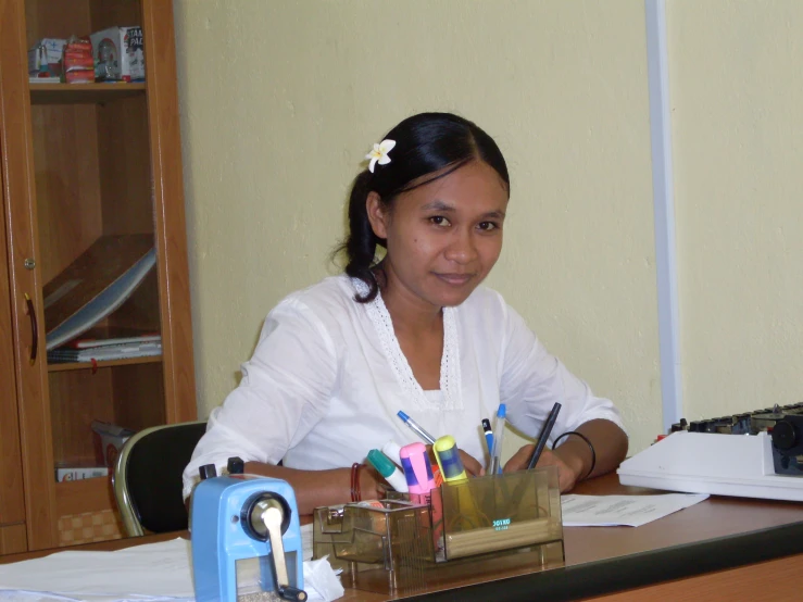 a young lady that is sitting at her desk