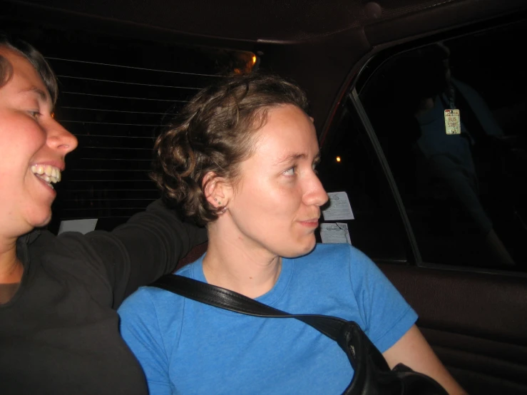 a man sitting next to a woman in a car