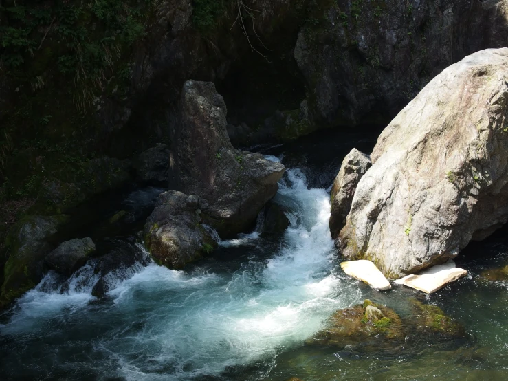 a river with some rocks and water coming out